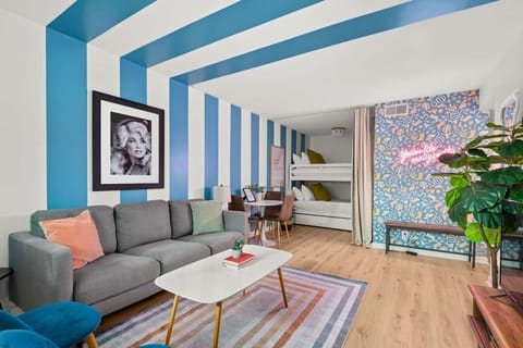 Bold blue striped walls and a Marilyn Monroe print give this living space an effortlessly cool, retro vibe.