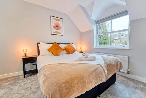 Cozy bedroom with soft lighting, plush bedding, and peaceful ambiance.
