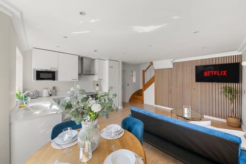 Bright open-plan living room with modern kitchen and cozy seating