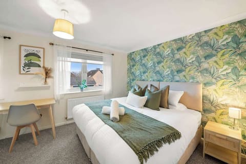 Relaxing bedroom featuring modern accents fresh greenery and calming tones