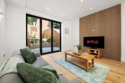 Bright modern living room with Netflix, cozy sofa, natural light