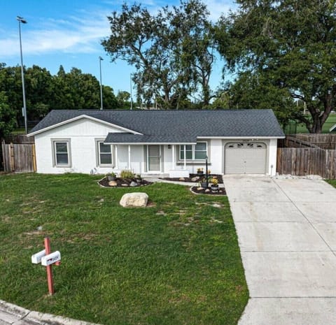 Charming single-story home with spacious yard, driveway, and great curb appeal