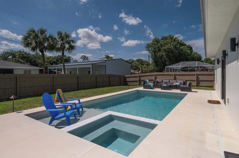 Relax by the private pool with comfortable seating and sunny skies.