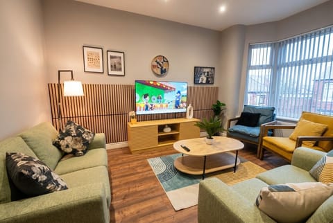 Stylish lounge with slatted feature wall and smart TV for cosy nights in.