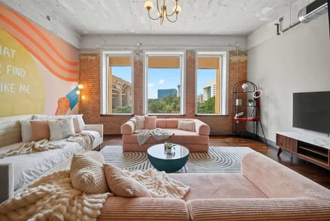 Lounge in Lyrics – blush sofas, big windows, and a mural declaring: “I promise that you’ll never find another like me.”
