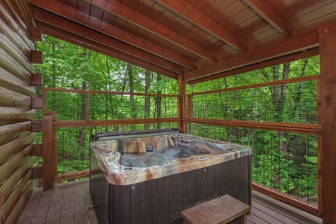 Slip into your bubbling hot tub and let the lush forest views melt your stress away.