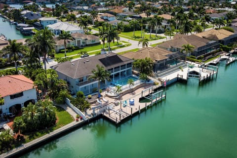 Canal waterfront vacation home with private dock, pool, and direct gulf access in a residential neighborhood.