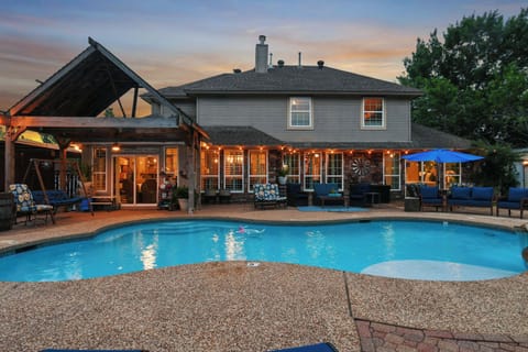 Dive into your private backyard retreat with a sparkling pool, covered lounge, and sunset vibes.
