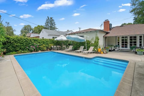 Private Backyard Pool with Lounge Chairs and Lush Garden
