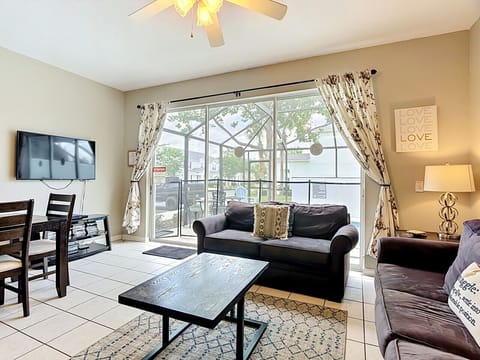 Cozy lounge area with large sliding doors opening to the screened patio