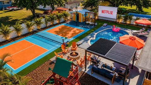 Outdoor Oasis: Enjoy vibrant tennis courts, a sparkling pool, and a cozy fire pit for fun nights!