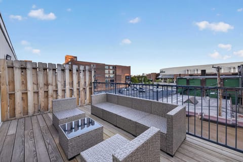 Private rooftop patio w/ lounge seating & open-air city views for relaxing day or night