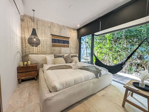 Unwind in this beautifully designed bedroom featuring floor-to-ceiling windows and a relaxing connection to nature.