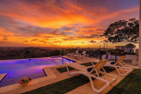 Unwind by the glowing pool as the sky turns golden and the views come alive