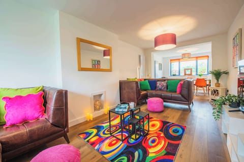 Sink into the colourful lounge after a day exploring the Yorkshire Dales, with cosy seating, warm lighting and plenty of space to unwind together.