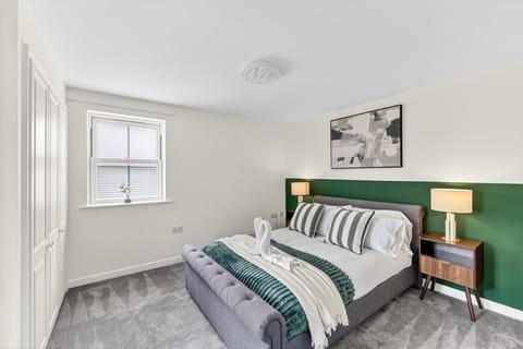 Bedroom 1 features a private ensuite bathroom and a comfortable double bed, complete with fresh linen and complimentary towels for your stay.