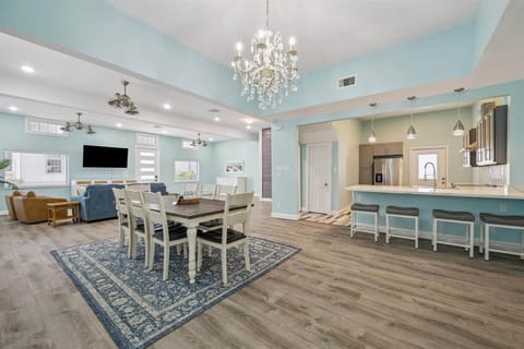 Dining room next to bar with bar stools 