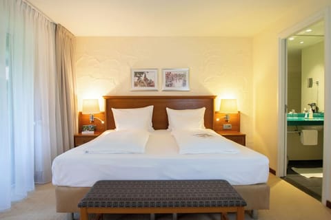 Drift off easily in a plush bed with warm bedside lighting
