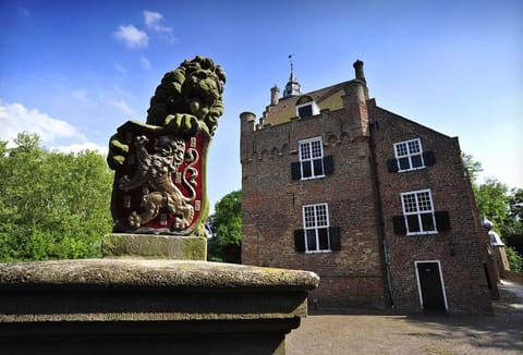 Admire timeless brickwork and heraldic charm under blue skies.
