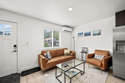 Sink into plush leather seating in your bright, modern living space. Natural light floods through large windows, while air conditioning keeps you comfortable year-round. The open layout connects you to the kitchen for easy entertaining.