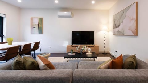 Open-plan living and dining area designed for comfort, featuring stylish furnishings and plenty of natural light.