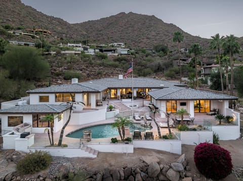 Welcome to Mirrored Palm! Perched against the hillside with sweeping panoramic views, this stunning desert retreat blends striking architecture, resort-style outdoor living, and ultimate privacy in an unforgettable setting.