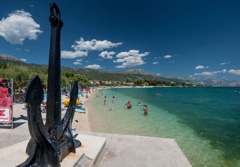 Beach nearby, white sand, beach towels