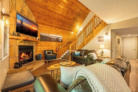 Sink into plush seating by the stone fireplace as vaulted wood ceilings create a warm, mountain-lodge atmosphere perfect for cozy evenings in.