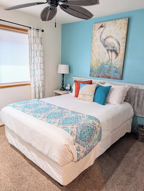 Designed for a restful night's sleep, this bedroom features a ceiling fan and is just steps from the air-conditioned living space.