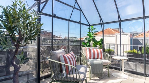 Sunlit rooftop greenhouse for slow mornings and sunset wine moments #PortoStay #AirbnbPorto