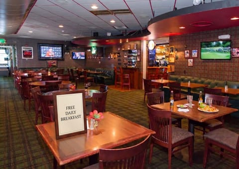 Chadwick's Pub & Grill interior with booth seating and multiple TV screens — live comedy runs Friday and Saturday nights.