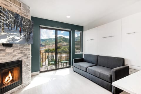 Gather around the fire or take in mountain views from your cozy living area with a sofa and floor-to-ceiling glass doors.