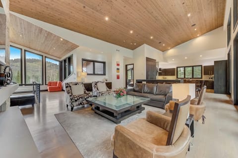 Soaring ceilings, forest views, and a stone fireplace set the tone for mountain comfort.
