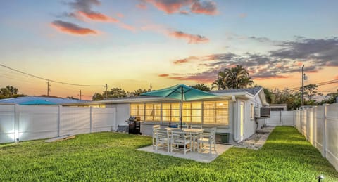 Private backyard with outdoor dining and sunset views.