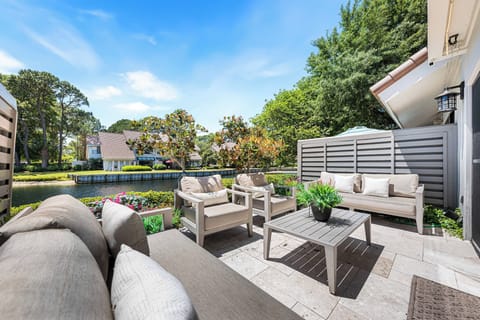 Unwind on the patio with comfortable seating and a coffee table. It offers a quiet view of the lake.