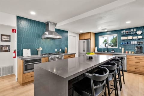 Fully stocked chef's kitchen with oversized island seating for six