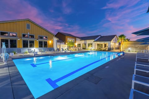 The resort-style communal pool deck is illuminated at night, creating a truly magical atmosphere.