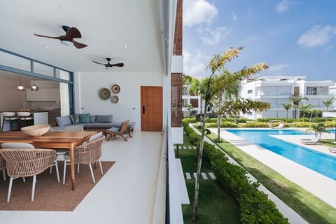 Spacious terrace with dining and lounge areas overlooking the pool and landscaped grounds.