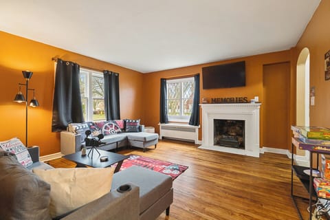 Cozy lounge with fireplace, smart TV, games & sunny windows