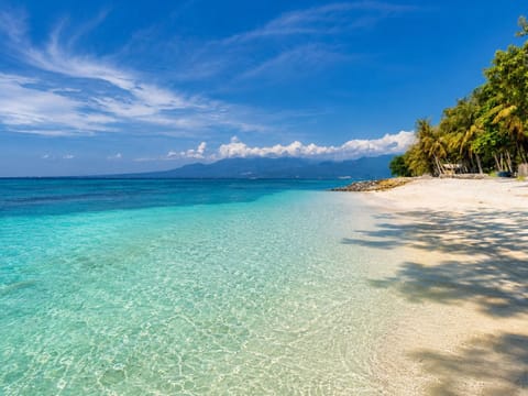 On the beach, white sand, sun loungers, beach umbrellas