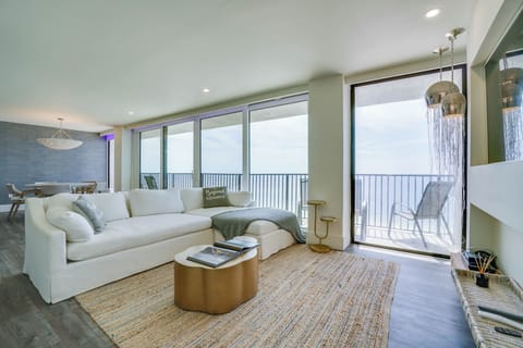 Your coastal sanctuary awaits with plush seating, elegant lighting, and sliding doors that open to your private balcony overlooking tranquil sea views.