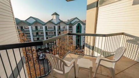 Private balcony with seating overlooking the resort grounds.
