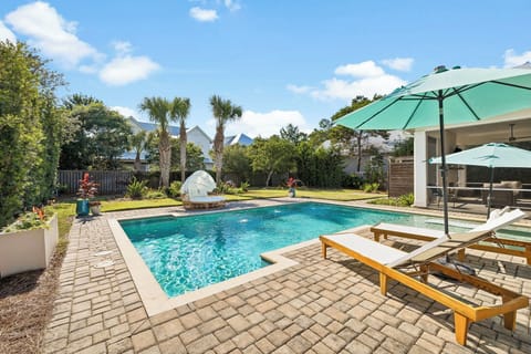 A sparkling private pool surrounded by sun loungers and tropical palms awaits your arrival. Unwind under the shade of turquoise umbrellas or soak up the sun in this peaceful outdoor retreat.