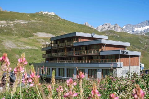Alpine wildflowers frame the entrance in summer, with the resort sitting at 2,150m above sea level