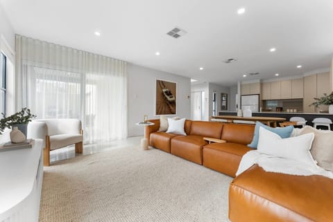 The open-plan layout flows effortlessly from the dining area to the lounge and kitchen, creating a bright social space for gathering, cooking and unwinding together.