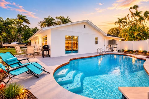 Lounge by the pool with ample seating options.
