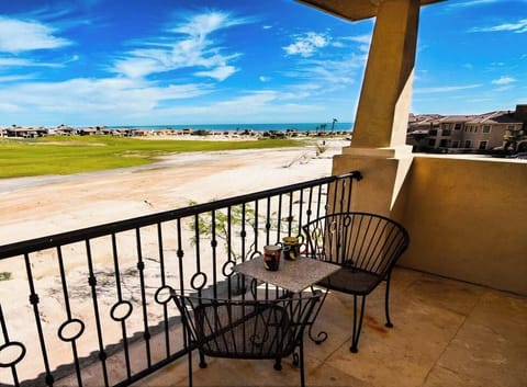 The private patio at Condo 37-2 overlooks the Las Caras de Mexico golf course — just steps from the community pool and private beach access.
