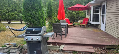 Pleasant outdoor seating area with grill and hammock