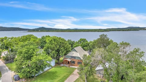 Perched on a quiet peninsula, a lakefront retreat offers panoramic water views.