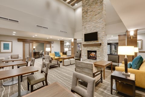 Cozy lounge with warm fireplace and comfortable seating for guests.
